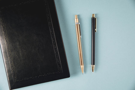 notebook and pens on the tableの写真素材