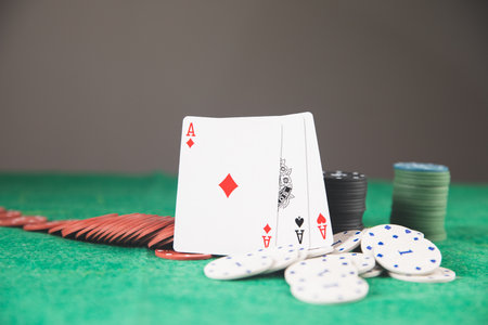 poker chips and cards on a green mat