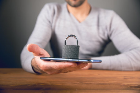 a man holding a phone and a lock