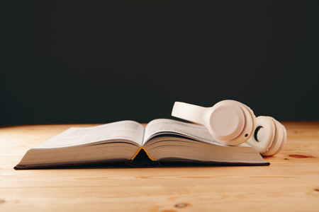 white white headphones on the book and a magnifierの写真素材