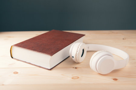 white white headphones on the book and a magnifierの写真素材