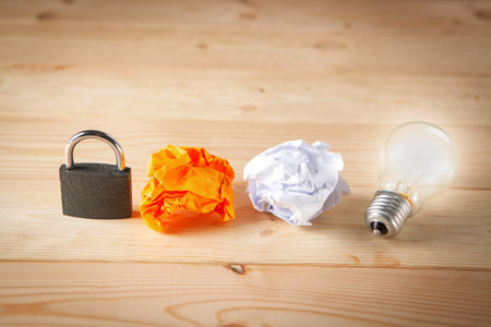 concept of hidden ideas and lock, lamp and wad of papers