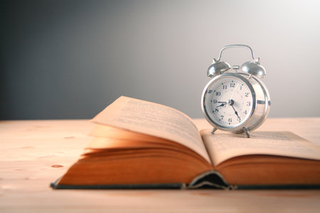 clock and book on the tableの写真素材