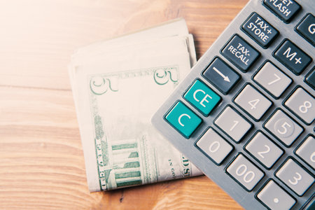 calculator and money on the tableの写真素材