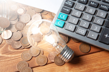 business idea concept. coins next to a calculator and a lamp on the table