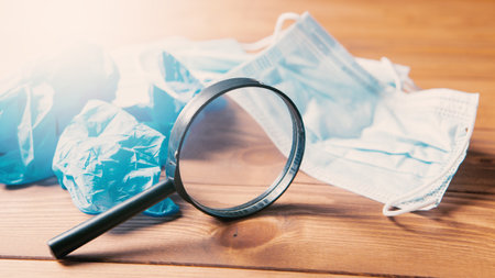 masks, gloves and a magnifying glass on the table