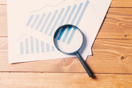 statistics and magnifying glass on the table