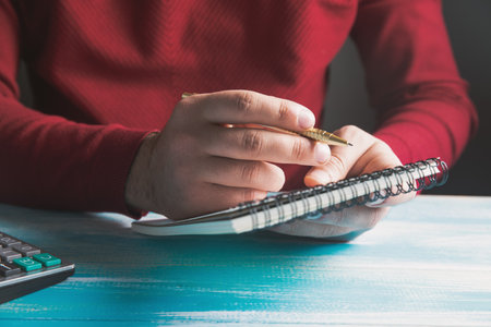 a young man writes in a notebook