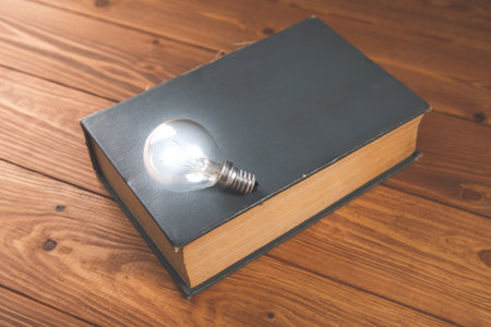 light bulb and book on the table new ideasの写真素材