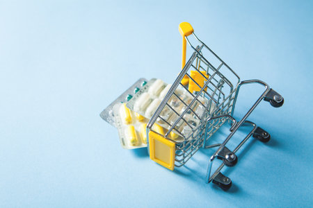 yellow basket with pills on a blue backgroundの写真素材