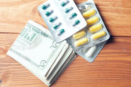 money and pills on a wooden table