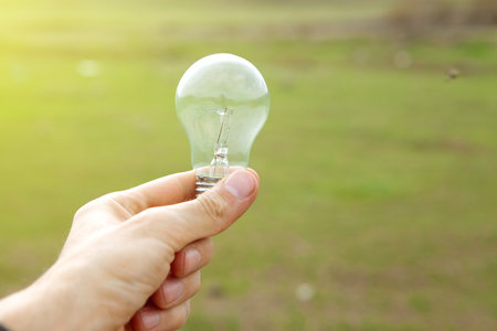 holding a lamp on the background of nature during the day