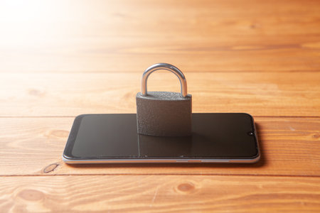 lock and phone on the tableの写真素材