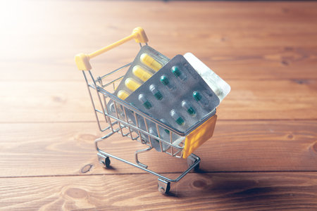 yellow basket with pills on wooden backgroundの写真素材