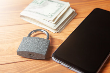 lock, money and phone on the tableの写真素材