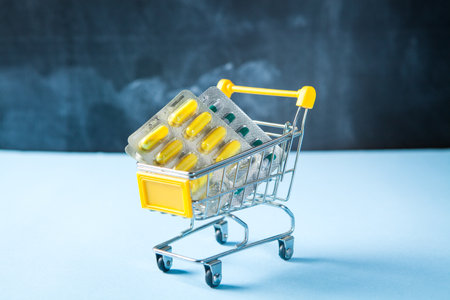 yellow basket with pills on a blue backgroundの写真素材
