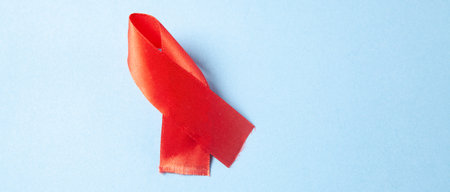red aids ribbon on blue backgroundの写真素材
