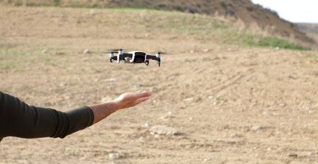 the drone lands on the palm of a man
