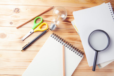 Concept study idea. magnifier, notepad, lamp and pen on the desktop