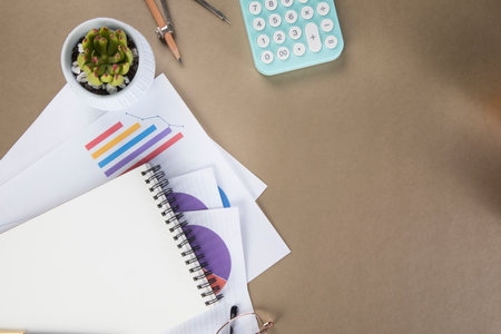 on the desktop with notepad, calculator, paper and glasses. desktop conceptの写真素材