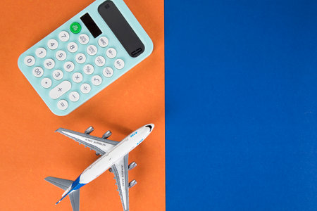 calculator and plane. travel counting concept. multicolored tableの写真素材