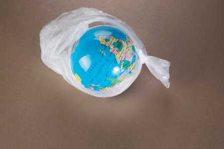 globe in a trash bag. ecological disaster concept. plastic problem