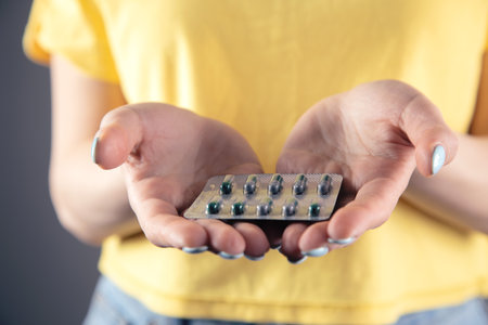 a girl in a yellow dress holding a pillの写真素材