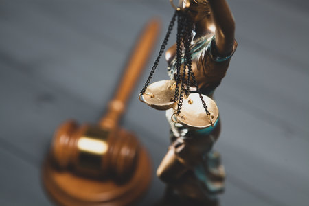 statue of justice and gavel of judge on gray background