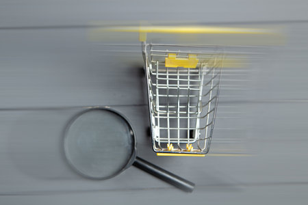magnifier and cart on gray wooden tableの写真素材