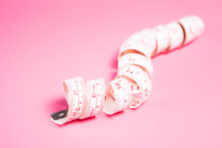 measuring tape on pink backgroundの写真素材