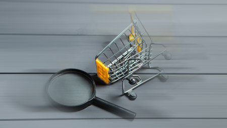 magnifier and cart on gray wooden tableの写真素材