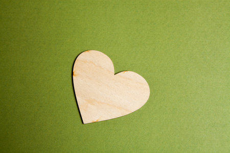 wooden heart on a green backgroundの写真素材