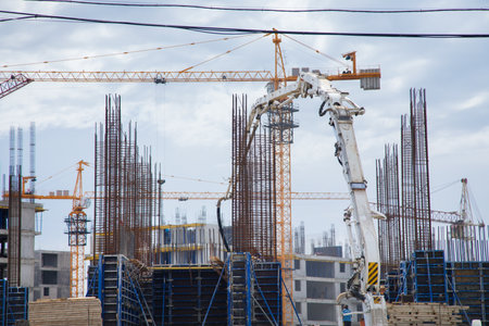 new building and cranes under the cloudsの写真素材