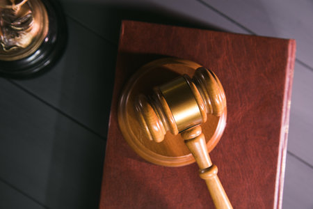 statue of justice, book and gavel on wooden table