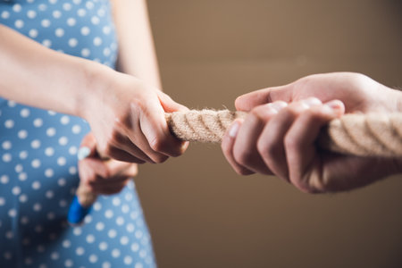 a man and a woman pulling the ropeの写真素材