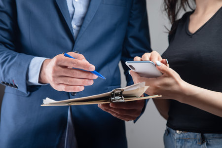 man and woman are discussing papers. partnership conceptの写真素材