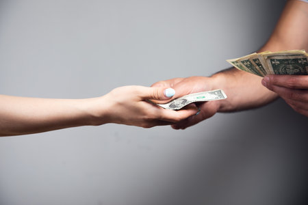 a man gives money to a womanの写真素材