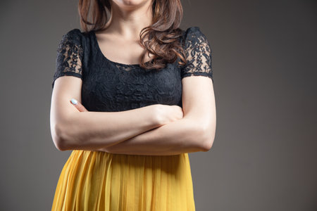 crossed her arms in a dressの写真素材