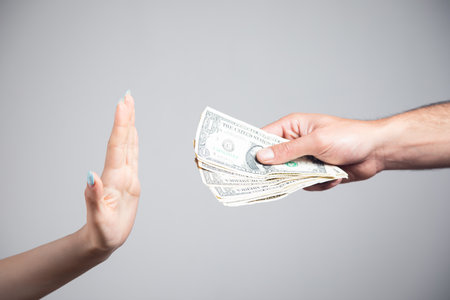 a woman refuses to accept money from a manの写真素材