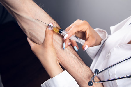 the doctor makes an injection. vaccination concept on gray backgroundの写真素材