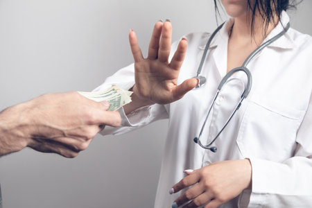 doctor refuses to accept money on gray backgroundの写真素材
