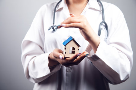the doctor protects the house. concept of house inspection due to quarantine. treatment of seven on a gray backgroundの写真素材