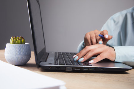 woman sitting in front of laptop and studying data in the officeの写真素材