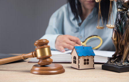 the judge examines the data about the house. property litigationの写真素材