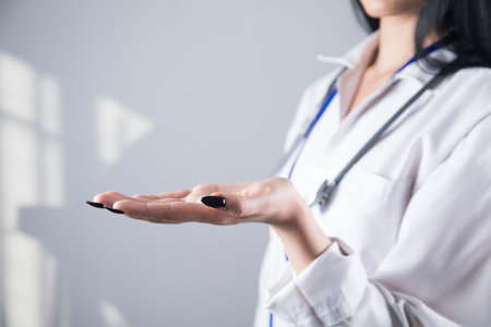 the doctor holds an empty palm as a standの写真素材