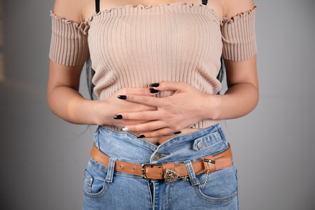 a young woman has a stomach acheの写真素材