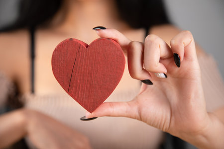 woman holding a wooden heartの写真素材