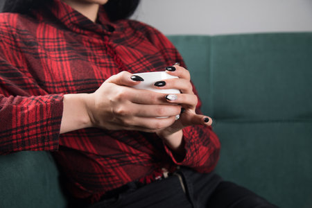 woman drinking tea while sitting on the couchの写真素材