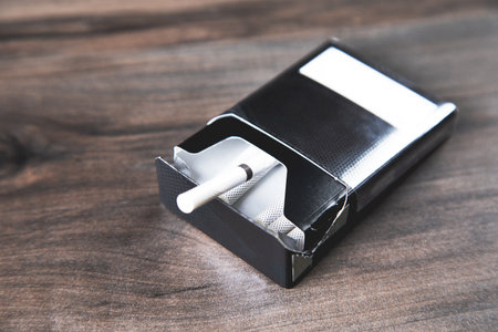 a pack of cigarettes on a wooden tableの写真素材