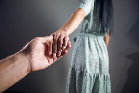woman holding a man's handの写真素材